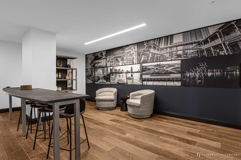 a dining room with a table and chairs and a black and white wall mural